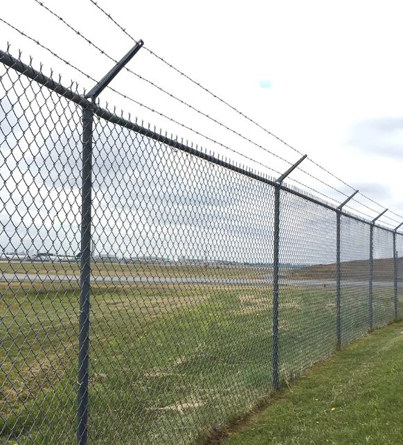 Commercial chain link security fence with barbed wire by ProGuard Fencing