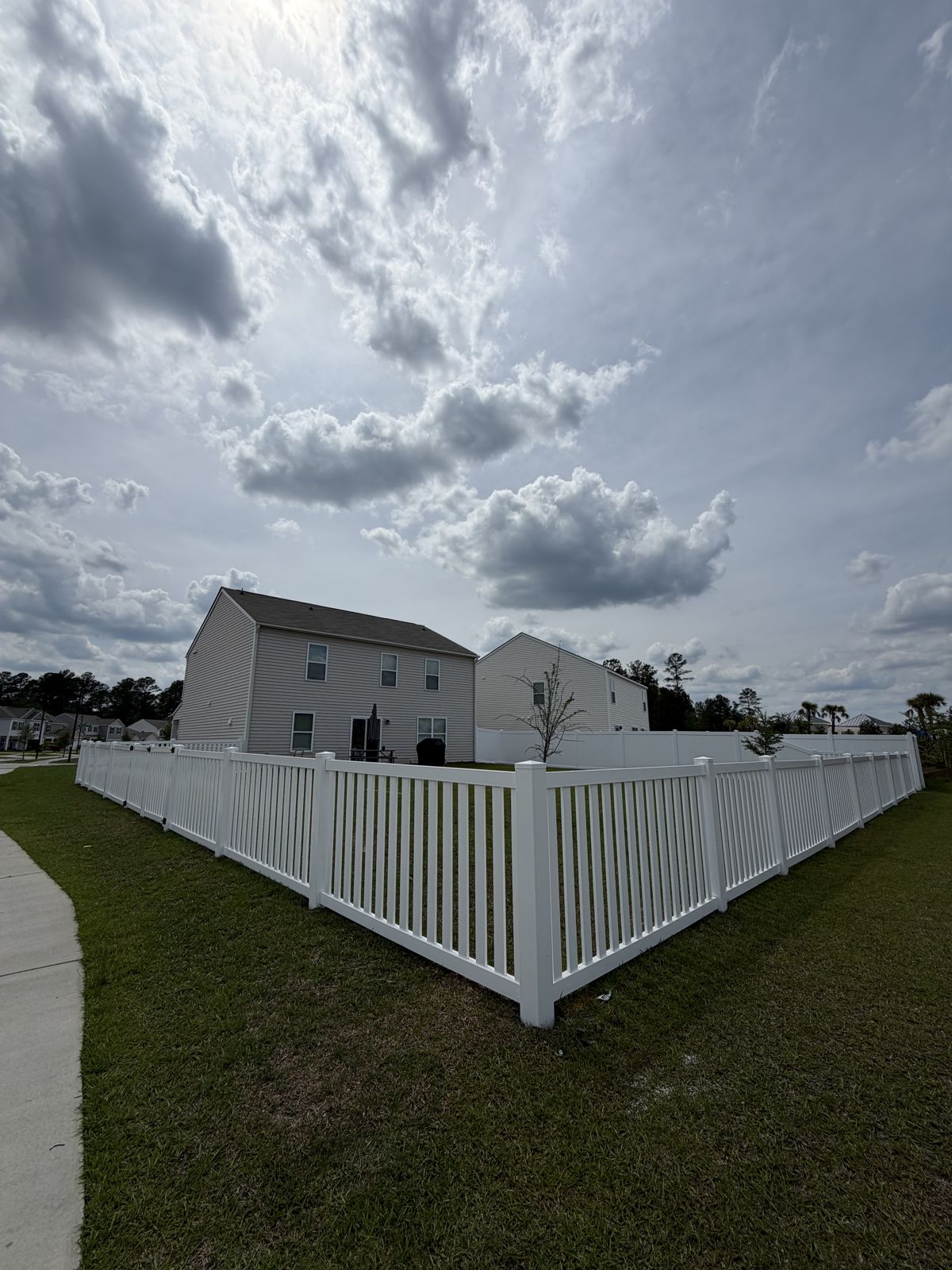 White vinyl picket fence corner by ProGuard Fencing